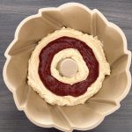Kuchenteig mit Marmeladenschicht in Gugelhupfform vor dem Backen